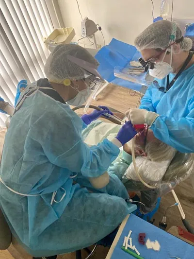 Dr. Oliveira providing emergency dental care for a patient at Lake Lucerne Lifestyle Dentistry in Orlando, FL