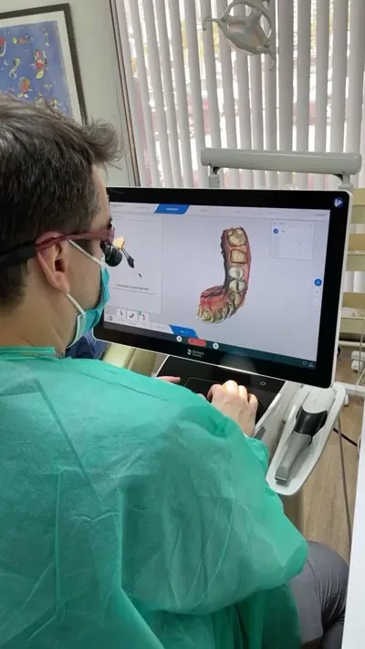 Dr. Oliveira reviewing a patient's dental x-rays to form a smile makeover plan
