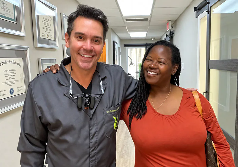 Dr. Oliveira smiling with a patient at Lake Lucerne Cosmetic and Implant Dentistry