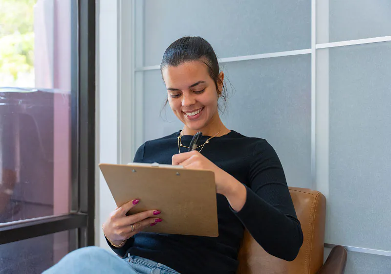 patient filling out her information at Lake Lucerne Cosmetic and Implant Dentistry